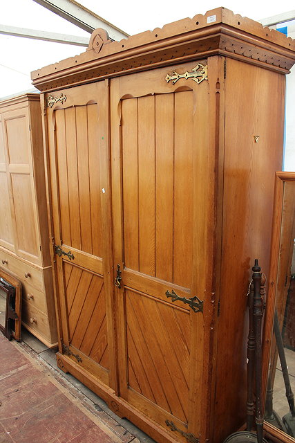 Appraisal: AN ARTS AND CRAFTS PINE DOUBLE WARDROBE with a carved