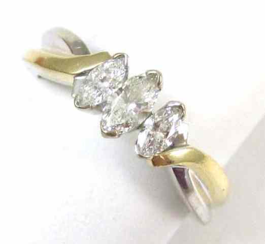 Appraisal: DIAMOND AND FOURTEEN KARAT GOLD RING The yellow and white