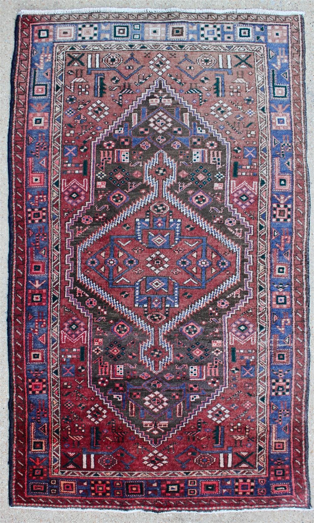 Appraisal: PERSIAN HAMADAN RUG having geometric patterns and central medallion on