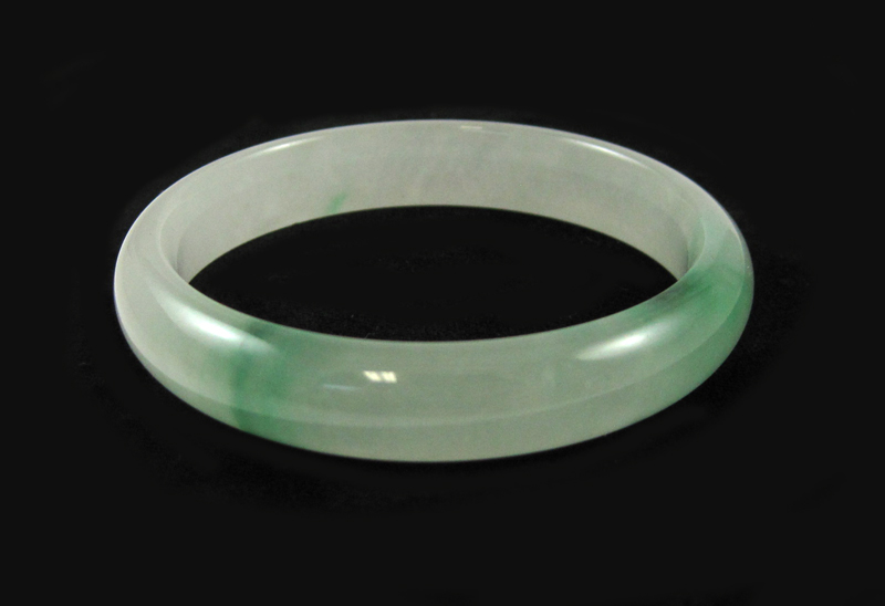 Appraisal: ROUND GREEN JADE BANGLE weighing grams and measuring mm in