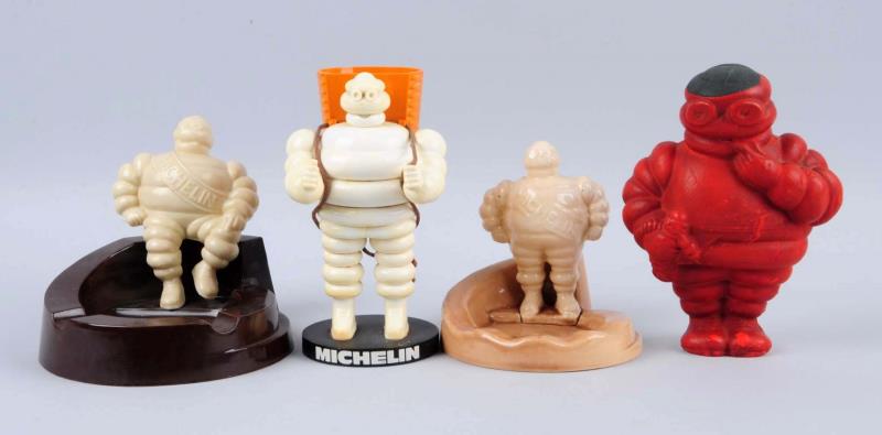 Appraisal: Lot of Michelin Men Figures Ashtrays The red figure is