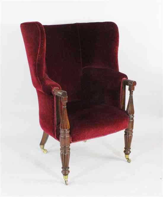 Appraisal: A Regency mahogany wing armchair with fluted frame and brass