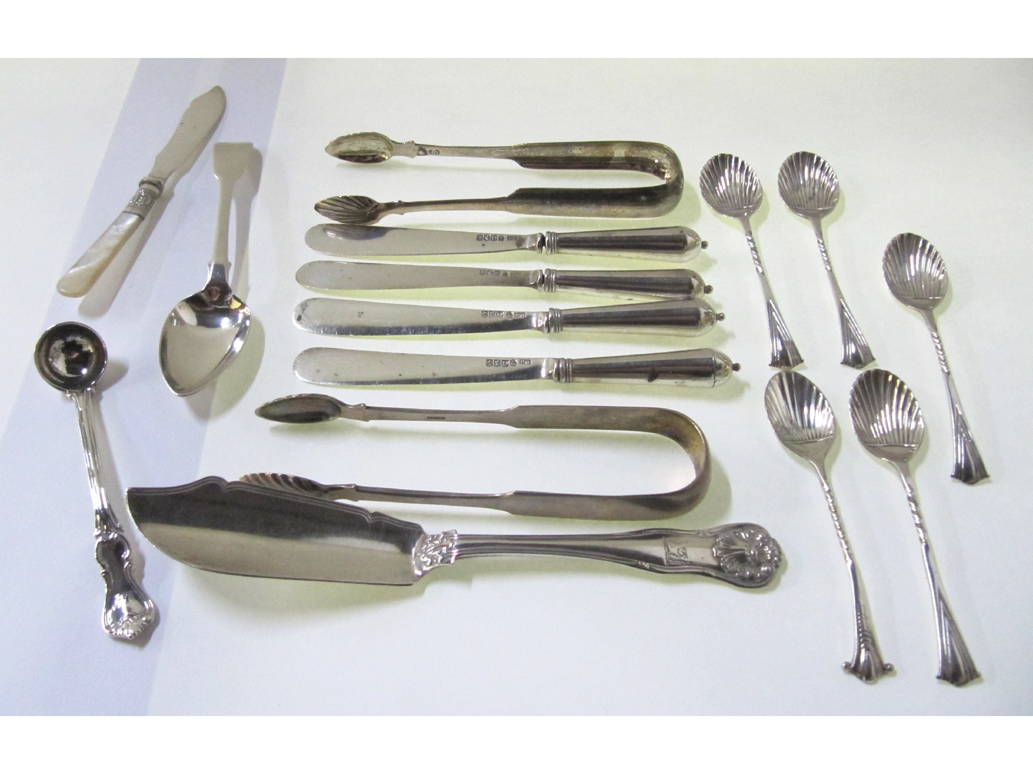 Appraisal: A lot comprising assorted silver spoons knives and sugar tongs