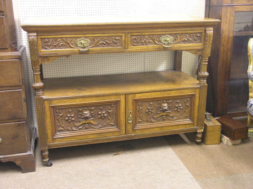 Appraisal: A Victorian pollarded oak buffet fitted with two carved frieze