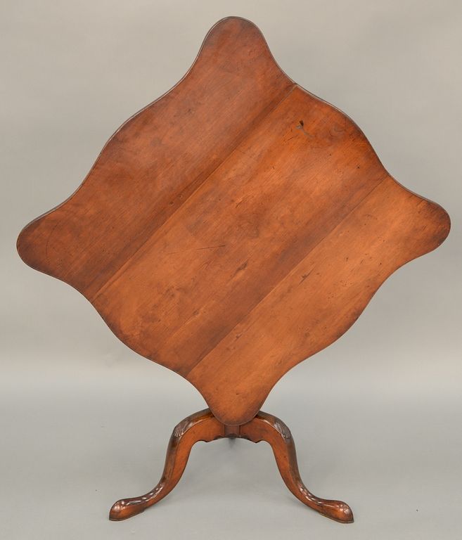 Appraisal: Federal cherry tip table having square serpentine edge top on