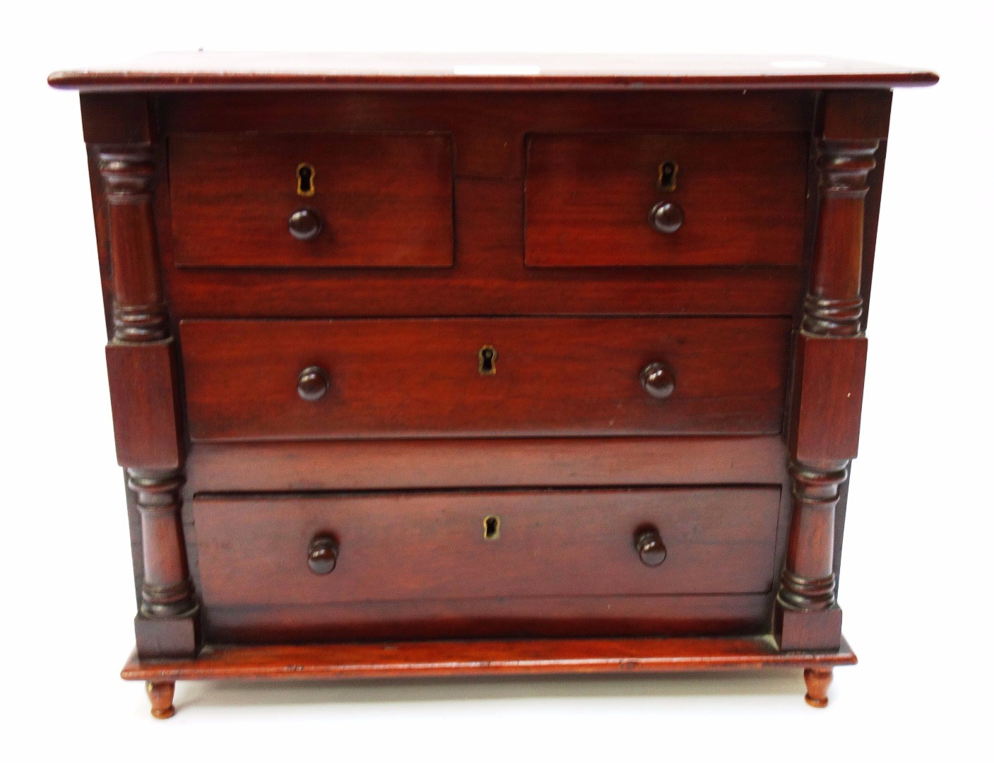 Appraisal: A th century mahogany miniature chest of two short and