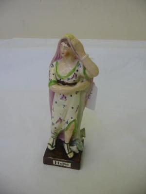 Appraisal: A STAFFORDSHIRE EARTHENWARE FIGURE Hope modelled as a maiden in