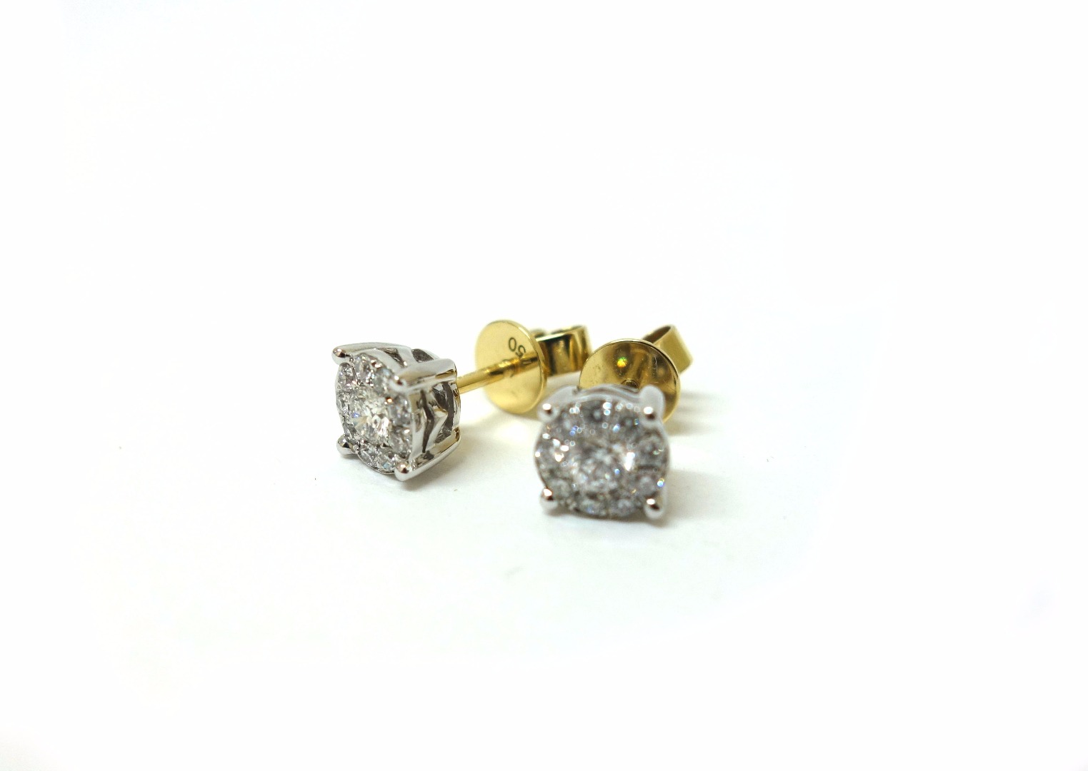 Appraisal: A pair of ten-stone brilliant-cut diamond cluster earrings four-claw set