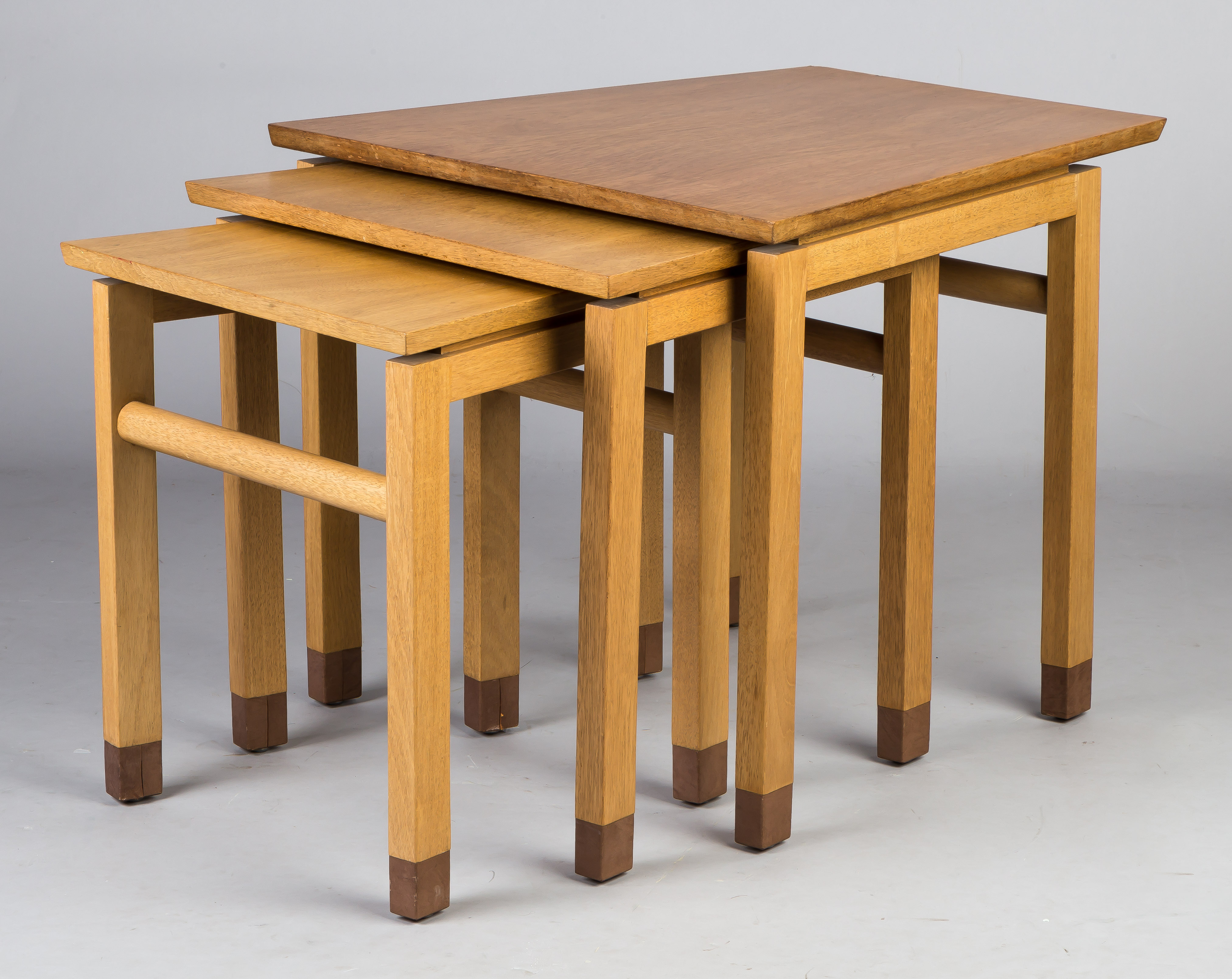 Appraisal: Dunbar Mid-Century Trapezoidal Nesting Tables Blonde mahogany with leather detail