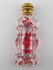 Appraisal: A gold mounted carved glass scent bottle with flashed ruby