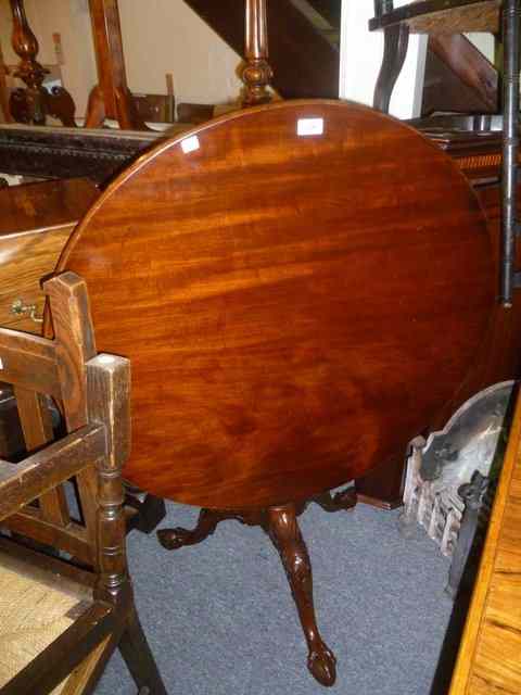 Appraisal: A GEORGIAN MAHOGANY TILT TOP TABLE with bird-cage action tapering