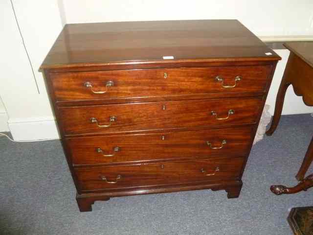 Appraisal: A GEORGIAN MAHOGANY CHEST of four long graduated drawers on