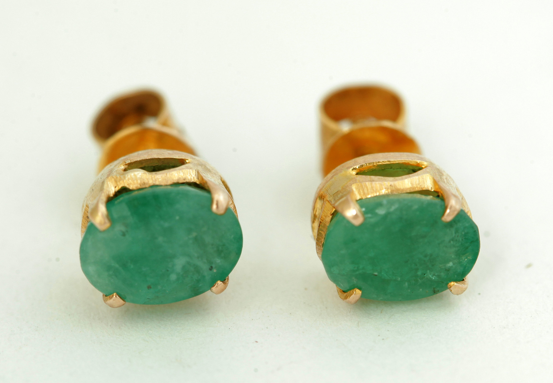 Appraisal: EMERALD EARRINGS Continental th century Unmarked gold screwback mounts with