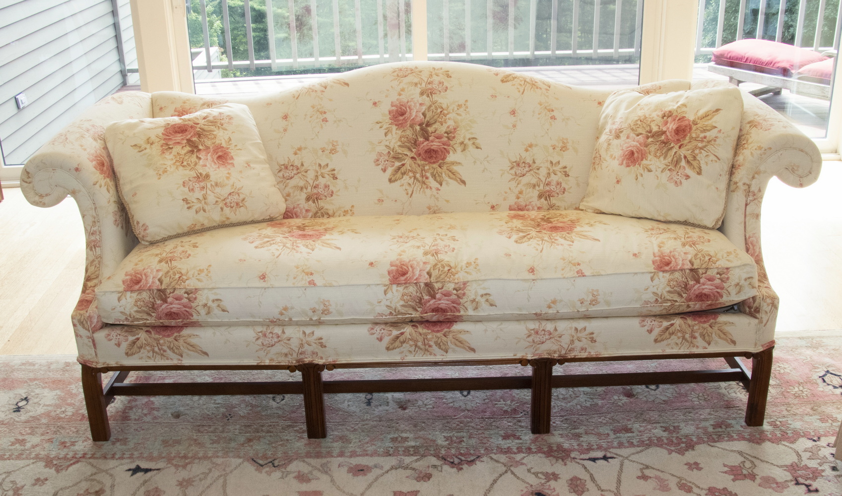 Appraisal: FLORAL PRINT SOFA WITH THROW PILLOWS A living room sofa