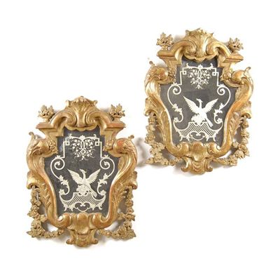 Appraisal: A pair of Italian carved giltwood cartouche shape mirrors each