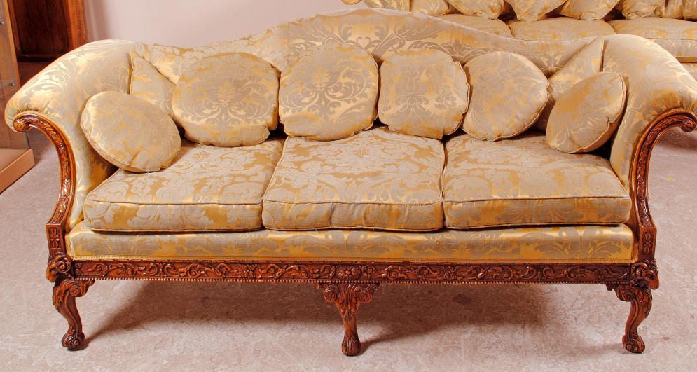 Appraisal: A CARVED MAHOGANY HUMP BACK SOFA of Georgian design upholstered