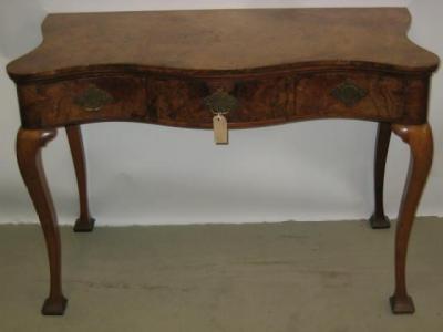 Appraisal: A BURR WALNUT SIDE TABLE of oblong serpentine form three