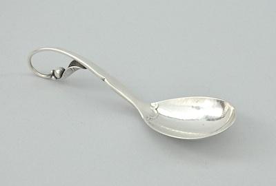 Appraisal: A Georg Jensen Sugar Spoon With the curvilinear handle terminating