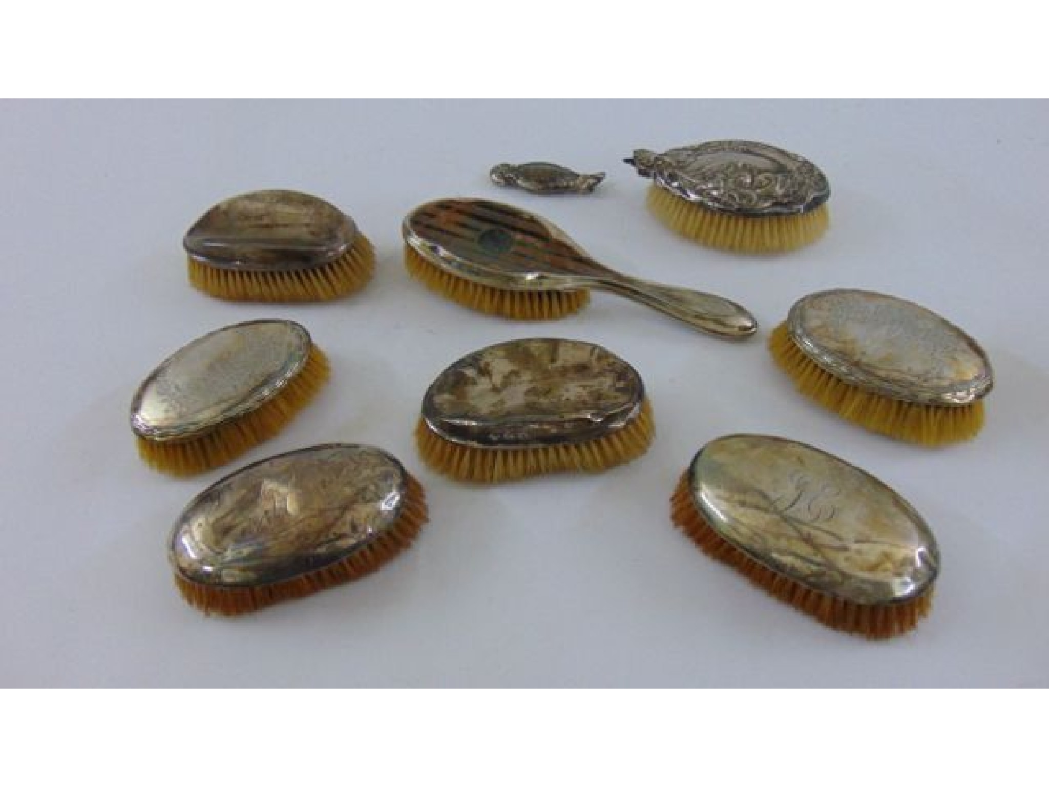 Appraisal: Seven various silver backed hair brushes with embossed plain and