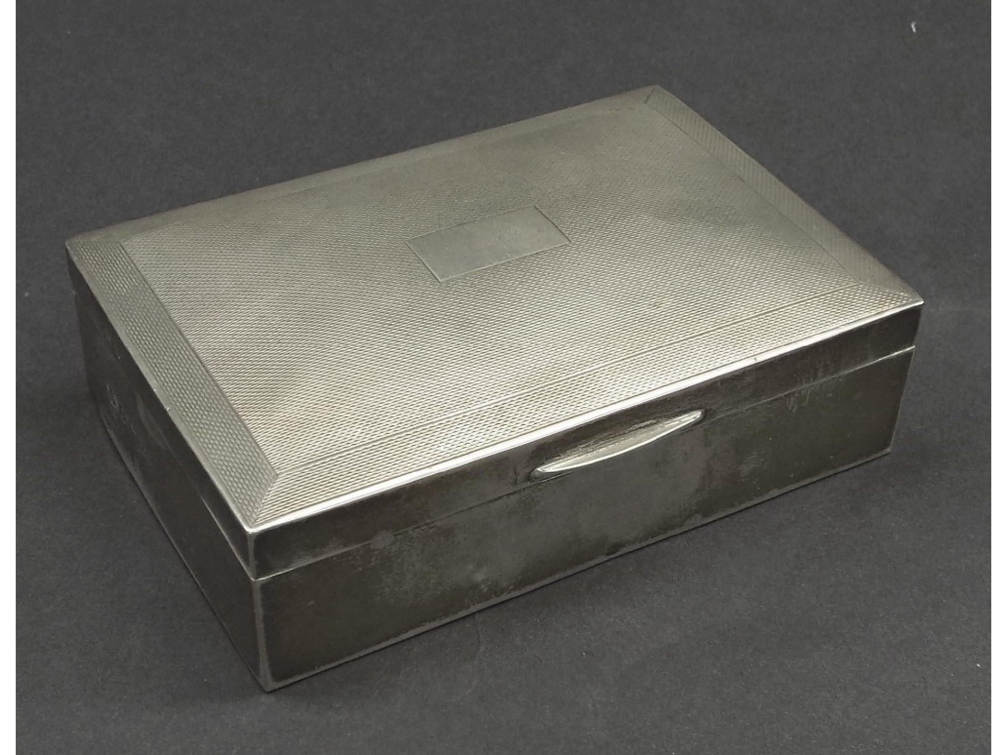 Appraisal: s engine turned silver cigarette box the hinged lid enclosing