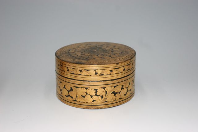 Appraisal: A Burmese lacquer box gold on black one inset compartment