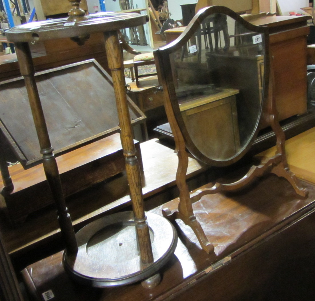 Appraisal: A mahogany shield shape toilet mirror and an oak stick