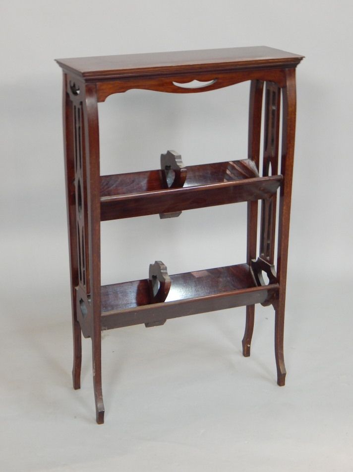 Appraisal: An Edwardian mahogany book rack the rectangular top on splayed