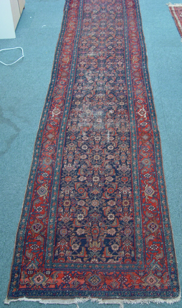 Appraisal: Rectangular carpet runner with multi coloured geometric decoration mostly reds