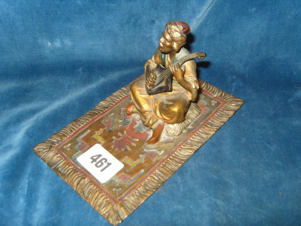 Appraisal: A Spelter figure of a seated Moroccan musician upon a