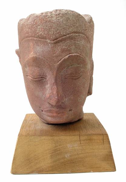 Appraisal: A Khmer style carved sandstone head of a deity mounted