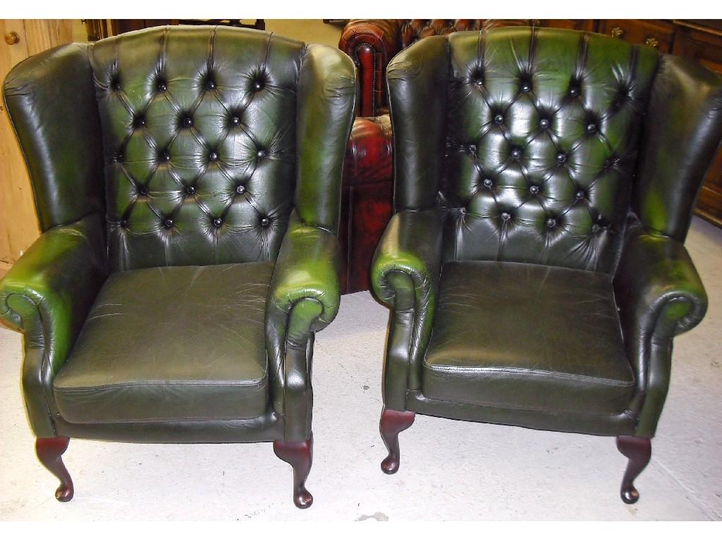 Appraisal: Pair of green leather button-back library wing armchairs