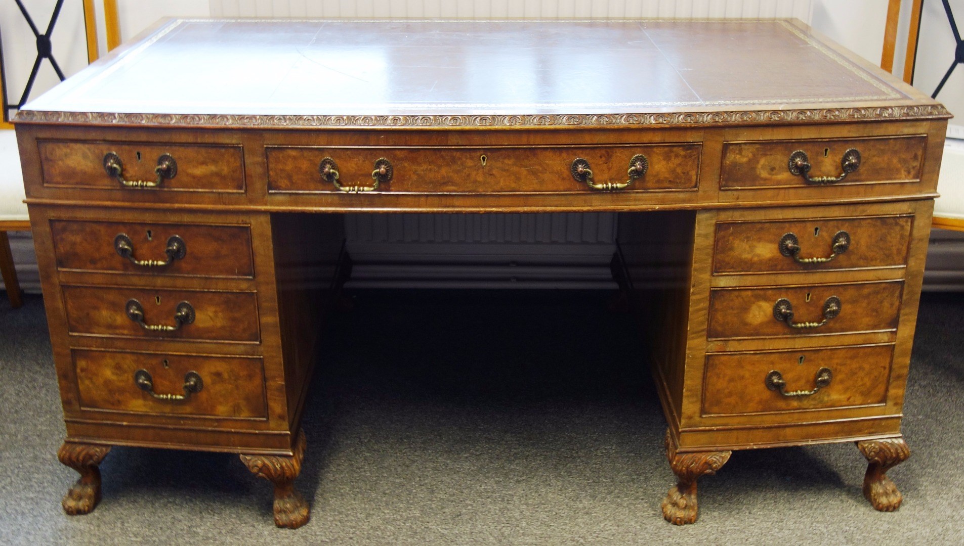 Appraisal: A th century figured walnut bowfront pedestal desk with nine