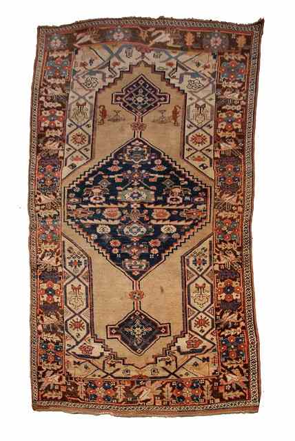 Appraisal: A BIDJAR BROWN GROUND RUG decorated a central large blue