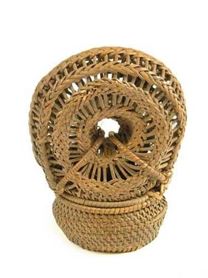 Appraisal: A woven wicker receptacle the oval bellied top to a