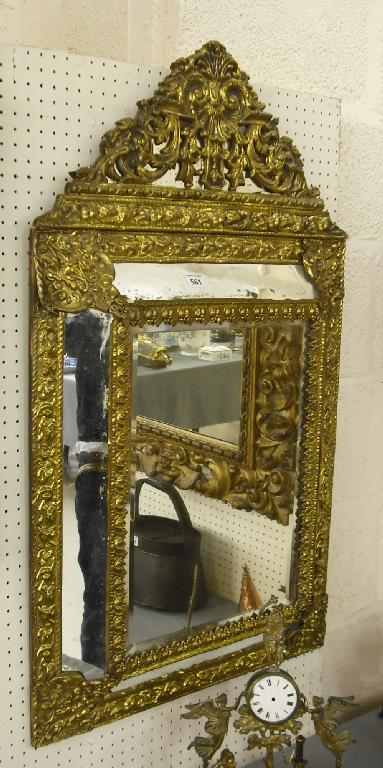 Appraisal: Repousse brass cushion mirror the main bevelled plate within foliate