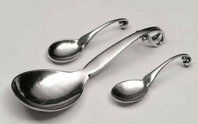 Appraisal: A GEORG JENSEN SILVER SPOON with scrolled and beaded handle