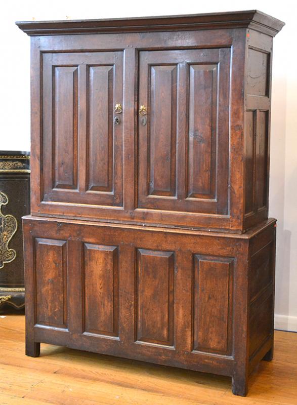 Appraisal: A GEORGE III OAK TWO DOOR PANELLED SIDE CABINETCIRCA