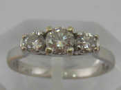 Appraisal: A white metal tests carat gold three stone diamond ring