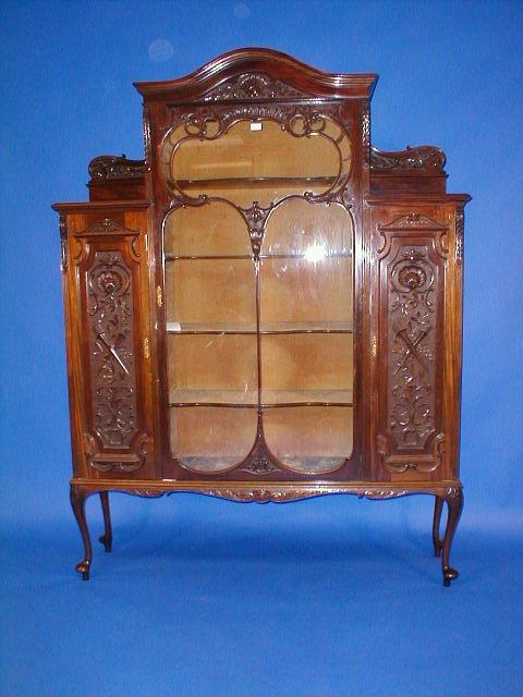 Appraisal: An Edwardian mahogany display cabinet with glazed rococo panel door