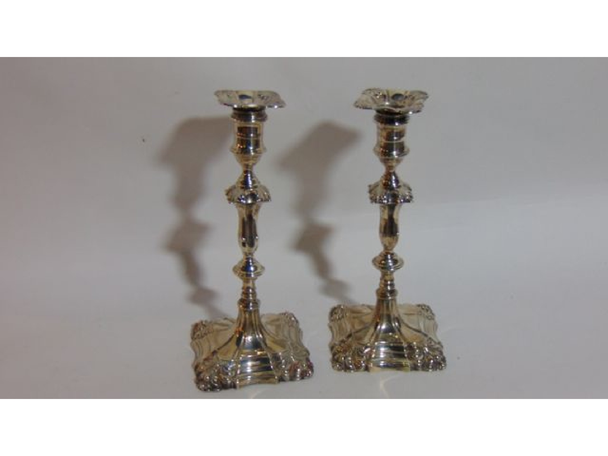 Appraisal: A pair of Edwardian silver candlesticks Thomas A Scott Sheffield