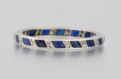 Appraisal: A Platinum Diamond and Sapphire Band Platinum band set all