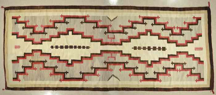 Appraisal: LARGE NAVAJO RUG hand woven in an overall geometric pattern