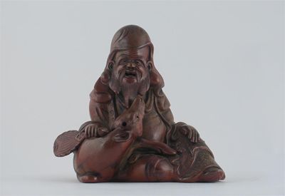 Appraisal: A Japanese Bizen pottery seated figure of Jurojin holding a