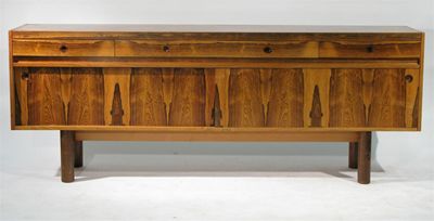 Appraisal: A rosewood sideboard probably Danish four drawers above two long