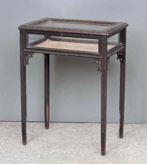 Appraisal: A late Victorian ebonised rectangular display table the top with