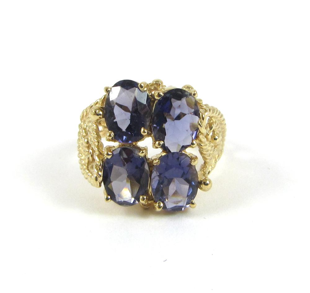 Appraisal: IOLITE AND FOURTEEN KARAT GOLD RING set with four oval-cut