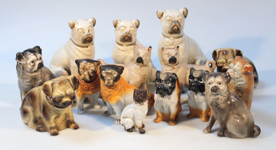 Appraisal: A pair of thC Staffordshire pottery free standing pug dogs