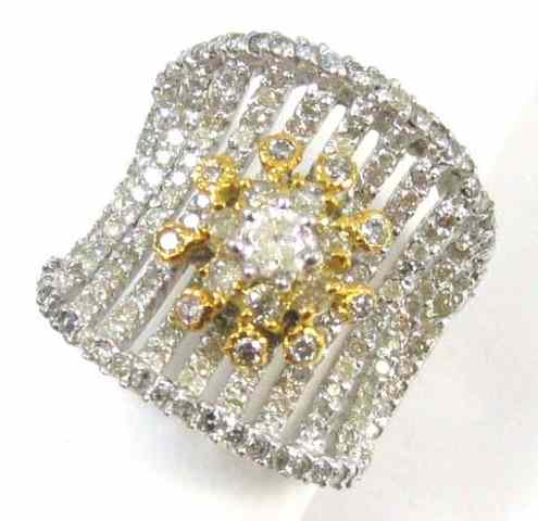 Appraisal: DIAMOND AND FOURTEEN KARAT GOLD RING The white and yellow