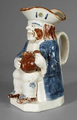 Appraisal: Pearlware Toby jug seated gentleman with blue coat holding an