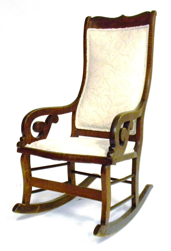 Appraisal: Figured maple scroll armchair rocker late th C shaped upholstered